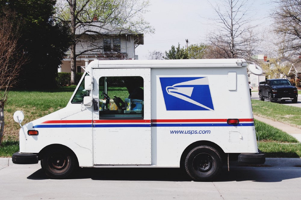USPS mail truck parked on a residential street